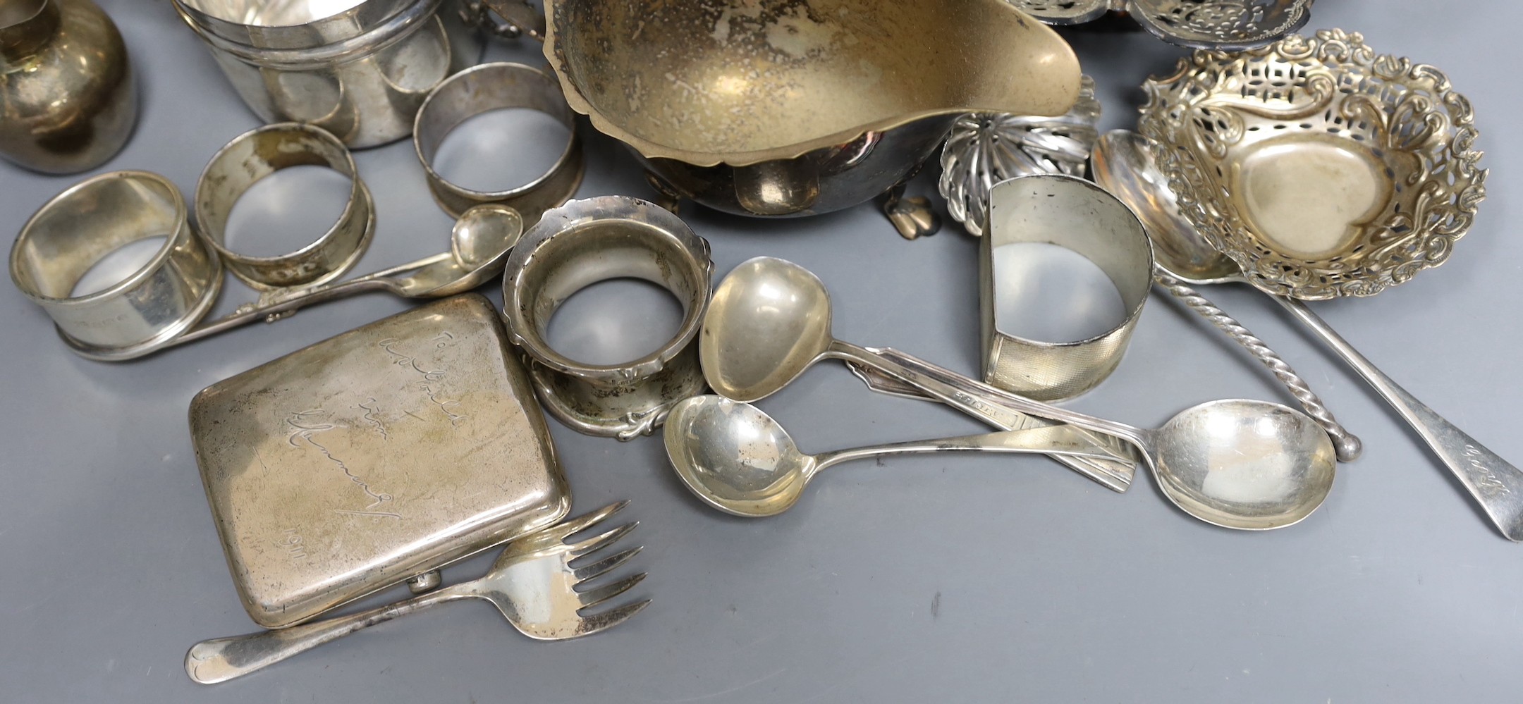 Assorted silver including a pair of posy vases, a small porringer, a pierced shallow bowl, a cigarette case, four napkin rings, a bonbon dish and six silver spoons, together with a French white metal cream jug and three